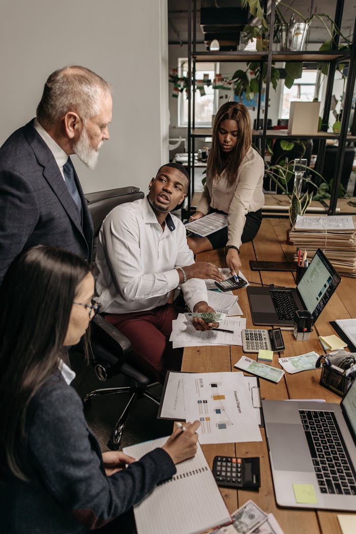 A diverse group of professionals engaging in a collaborative effort in the office.